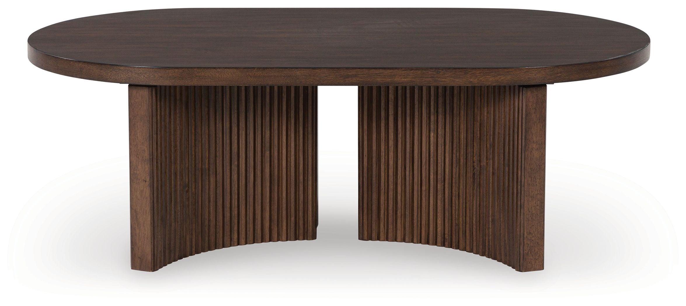 Signature Design by Ashley® - Korestone - Dark Brown - Oval Cocktail Table - 5th Avenue Furniture