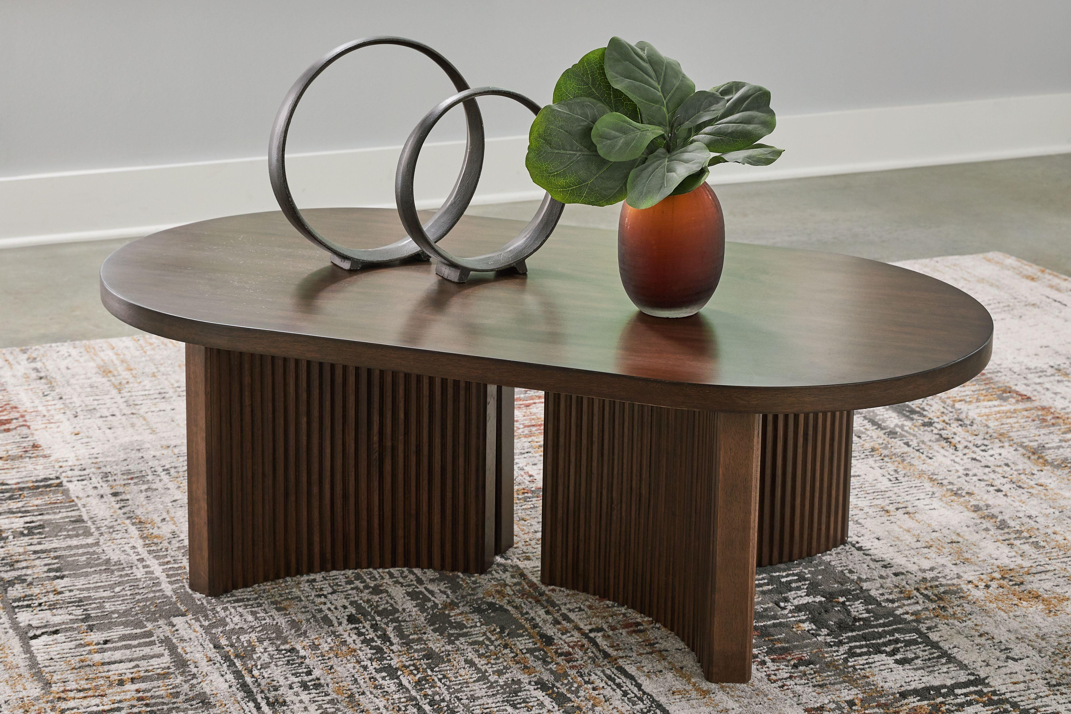 Signature Design by Ashley® - Korestone - Dark Brown - Oval Cocktail Table - 5th Avenue Furniture
