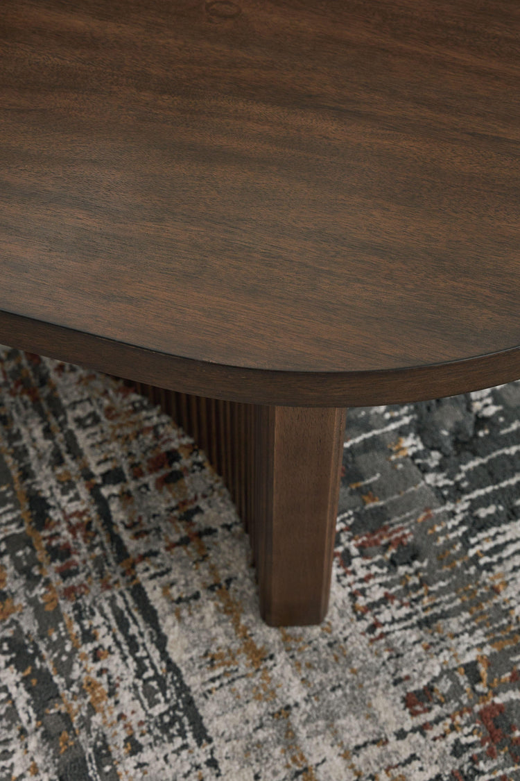 Signature Design by Ashley® - Korestone - Dark Brown - Oval Cocktail Table - 5th Avenue Furniture
