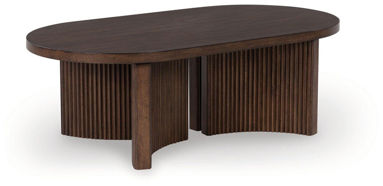 Signature Design by Ashley® - Korestone - Dark Brown - Oval Cocktail Table - 5th Avenue Furniture