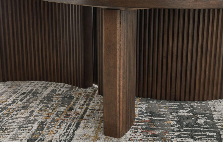 Signature Design by Ashley® - Korestone - Dark Brown - Oval Cocktail Table - 5th Avenue Furniture