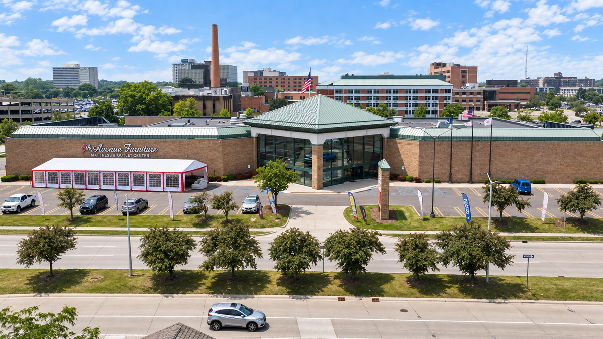 Composite view of the Southfield showroom with the red-and-white tent sale beside the entrance